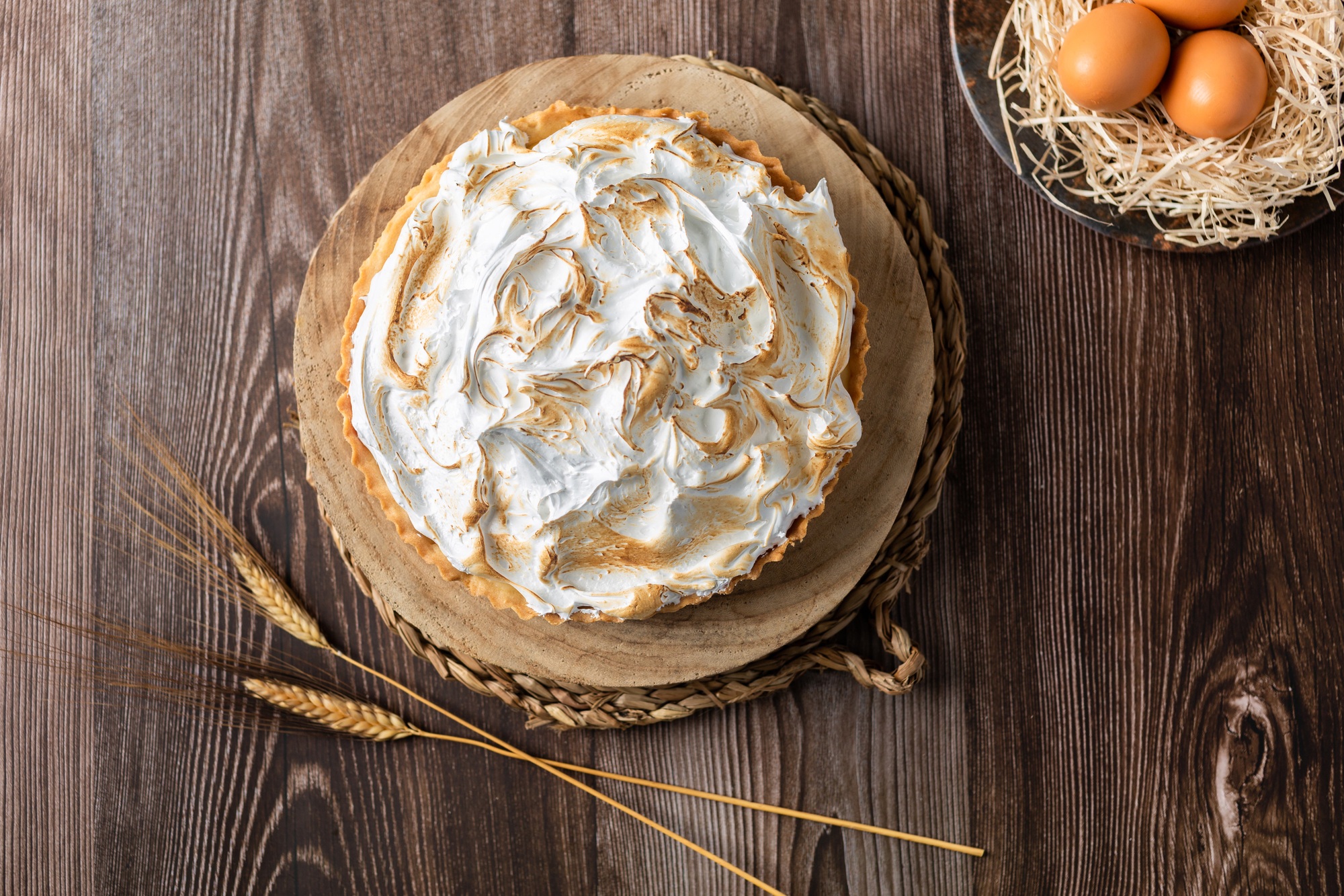 Lemon pie on top of log and wooden table. zenithal view
